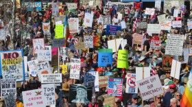 large crowd of people with protest signs