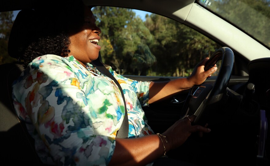 Jaquelyn “Jackie” King, a rideshare driver for the company Uber, laughs with rider Jimmy Rochelle on the way to his home in Micanopy, Fla., on Thursday, Nov. 20, 2025.
