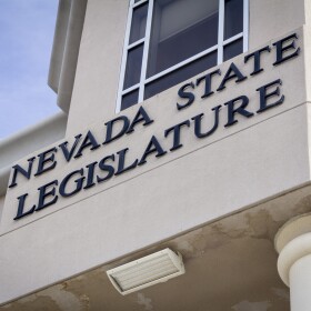 An image of the exterior of the Nevada State Legislature building, with black lettering of the words: Nevada State Legislature. 