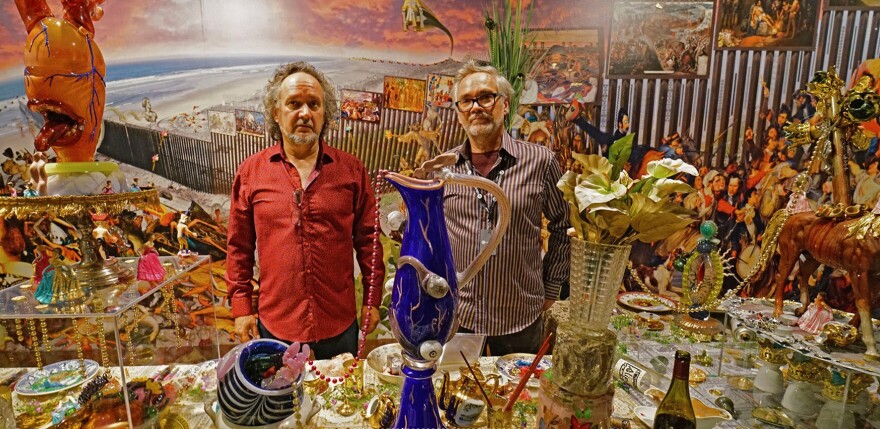 Brothers Jamex (left) and Einar de la Torres stand in front of their glass-blown creations. Their work is on display through Sept. 21 at the Mint Museum Uptown.