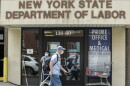 Pedestrians pass the New York State Department of Labor office.