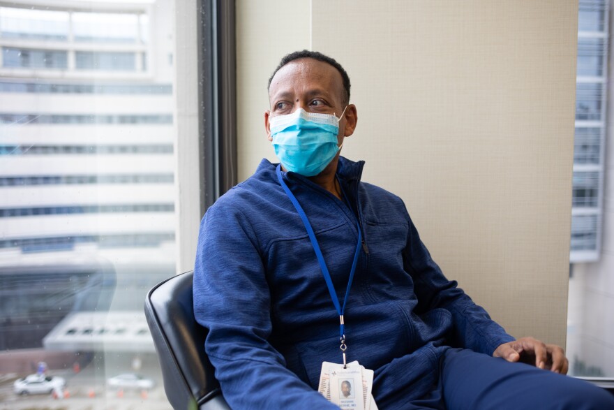 Dr. Mezgebe Behre poses for a portrait in his office.