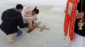 Father Michael Trefon of Bethel's St. Sophia Orthodox Church leads a Theophany ceremony on the Kuskokwim River near Bethel's boat harbor on January 19, 2019. The ritual is meant to recreate the baptism of Jesus Christ as described in the New Testament.