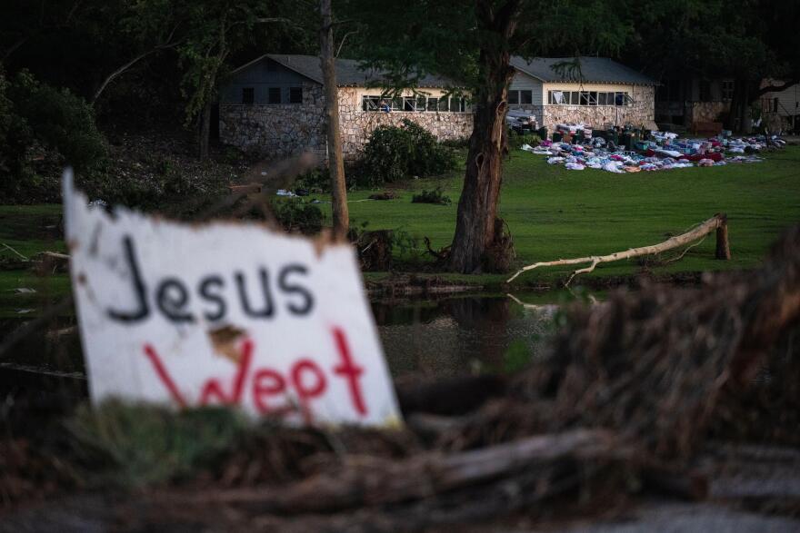FILE - Campers' belongings sit outside one of Camp Mystic's cabins near the Guadalupe River, Monday, July 7, 2025, in Hunt, Texas, after a flash flood swept through the area. (AP Photo/Eli Hartman, File)