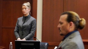 Amber Heard and Johnny Depp watch as the jury leaves the courtroom at the end of the day at the Fairfax County Circuit Courthouse in Fairfax, Virginia, May 16, 2022.(Steve Helber/POOL/AFP via Getty Images)