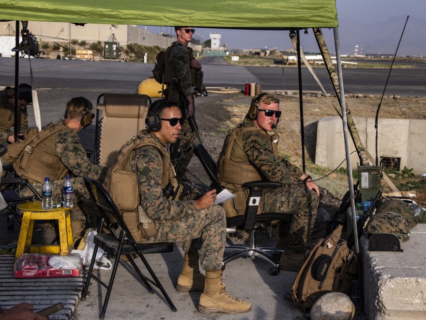 In this image provided by the U.S. Marine Corps, Marines assigned to the 24th Marine Expeditionary Unit monitor the air traffic control center at Hamid Karzai International Airport in Kabul, Afghanistan on Sunday, Aug. 22, 2021.