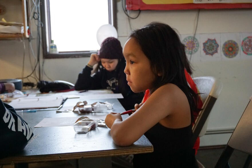 Skyla Foster, 10, takes notes during an OPT In Kiana meeting. (Hillman/Alaska Public Media)