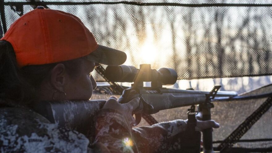 Emily Beasley lines up a shot from inside a hunting blind.