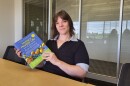 photo of Dallas Abraham holding the book "Living A Healthy Life"