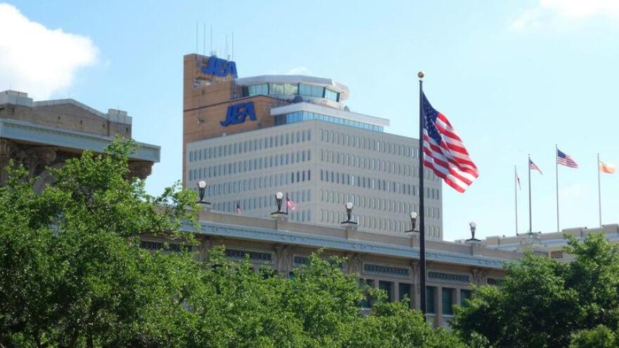 JEA's downtown headquarters building is pictured behind Jacksonville's City Hall.