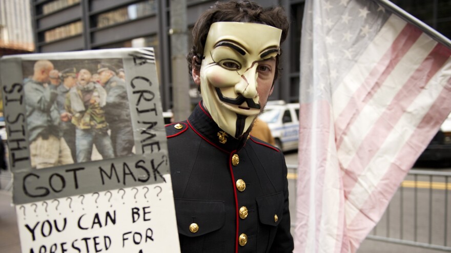 <strong><a href="http://www.npr.org/blogs/thetwo-way/2012/06/11/154750736/has-occupy-crashed-or-just-begun">New York</a>:</strong> A young man with an Anonymous mask marches with Occupy Wall Street protesters on Nov. 11, 2011, at Zuccotti Park in New York.