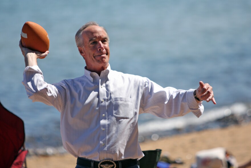 Former U.S. Interior Secretary Dirk Kempthorne tosses a football on the beach during a break from the 12th Annual Tahoe Summit in South Lake Tahoe, Calif., on Saturday, Aug. 16, 2008.