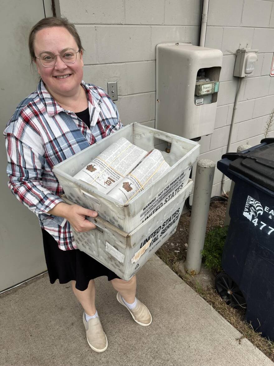Iron County Miner publisher and owner Autumn Hill takes the newspaper to the local post office in Hurley to be sent out for delivery.