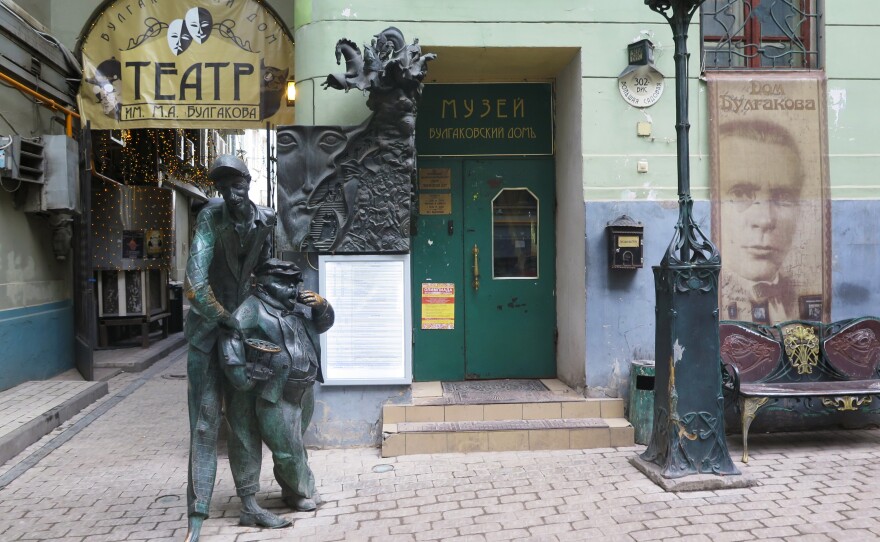 Statues of two devilish characters from <em>The M</em><em>aster and Margarita</em> greet visitors to the Bulgakov House Museum in Moscow. The exhibits combine memorabilia from the writer's life with whimsical displays and secret passages.