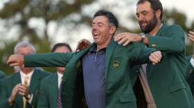 Scottie Scheffler puts the green Jacket on winner, Rory McIlroy, of Northern Ireland, at the Masters golf tournament, Sunday, April 13, 2025, in Augusta, Ga. (AP Photo/Ashley Landis)