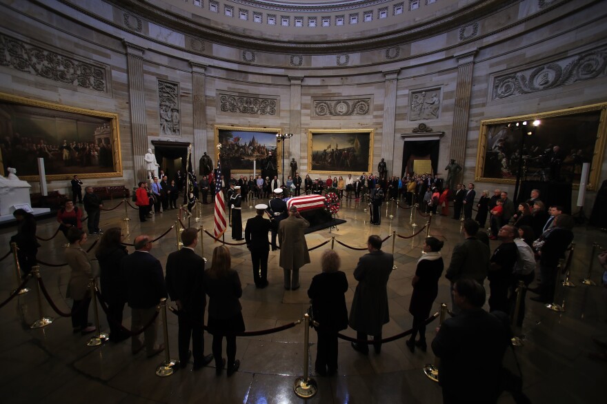 World War II veteran Emory Crowder, 95, center right, pays his last respect to fellow soldier former President George H.W. Bush as he lie in state at the U.S. Capitol in Washington, Tuesday, Dec. 4, 2018. 
