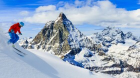Skiing with amazing view of swiss famous mountains in beautiful winter snow. Matterhorn, Zermatt, Swiss Alps.