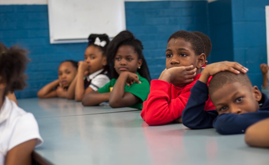 Students listen to a book reading during a giveaway event at Koch Elementary School in Riverview Gardens School District on March 2, 2017.