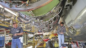 Mechanics work to reattach an engine to a MD-80 airline at the American Airlines maintenance facility in Tulsa. Highly trained professionals are needed to encourage aerospace growth in Oklahoma, said Brent Kisling, executive director of the OCD