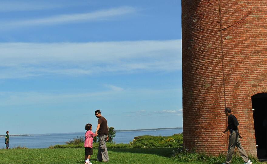 Former President Barack Obama (right) walks around Gay Head Lighthouse in 2009 during his family vacation on Martha's Vineyard, Mass.