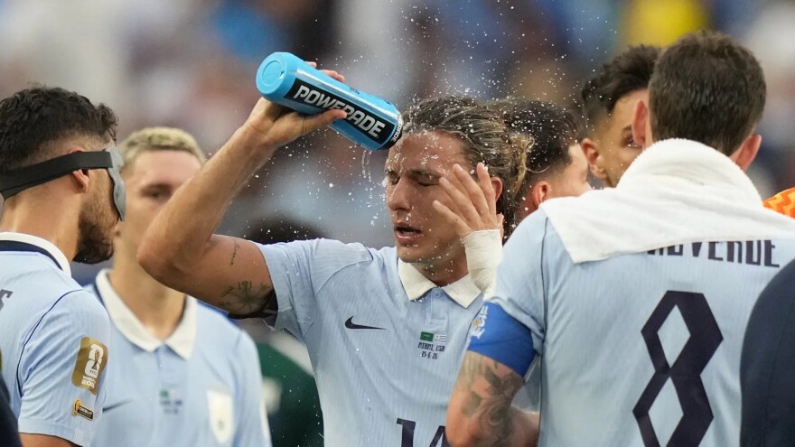 Uruguay’s Agustin Canobbio cools off during a hydration break during a match with Saudi Arabia on June 15.