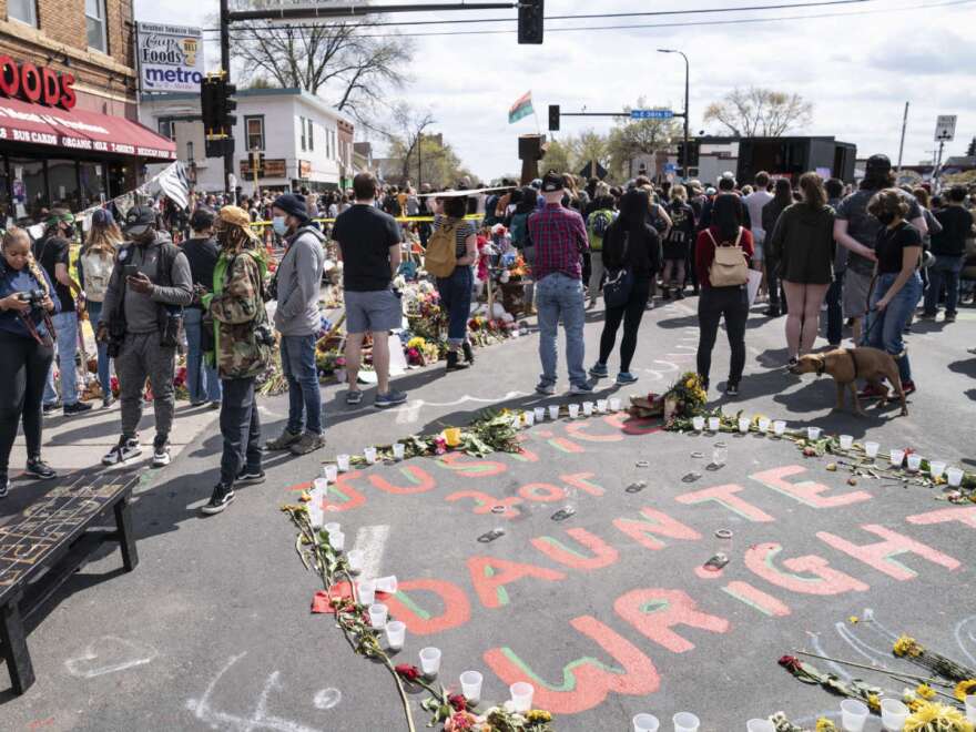 Demonstrators gather for a solidarity rally in memory of George Floyd and Daunte Wright outside Cup Foods, Sunday, April 18, 2021, in Minneapolis. (AP Photo/John Minchillo)