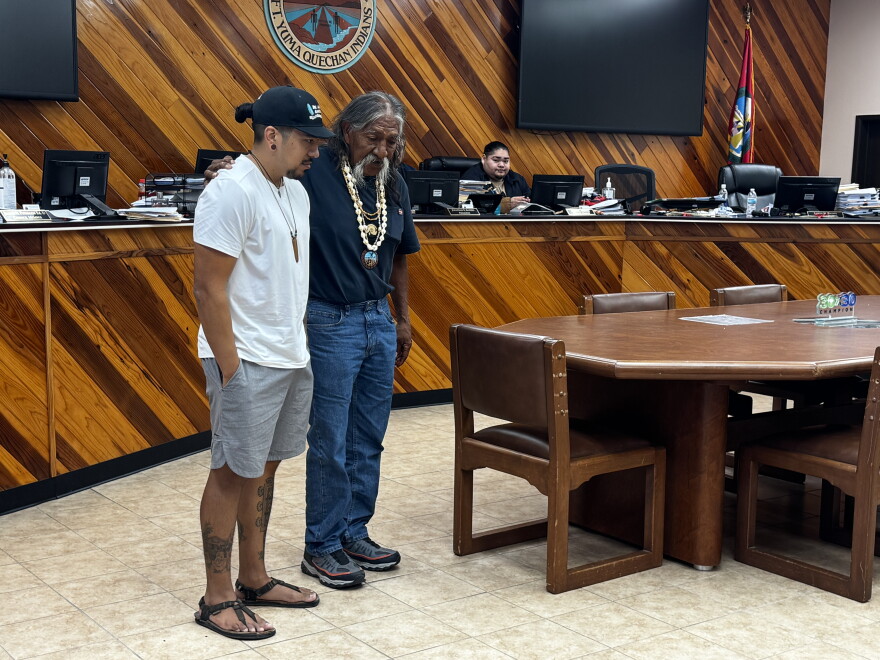 On the left is DJ Portugal, organizer of Ha'Kamwe (runners) and organizing Director at Chispa Az. On the right is elder Ivan Bender speaking to the families.