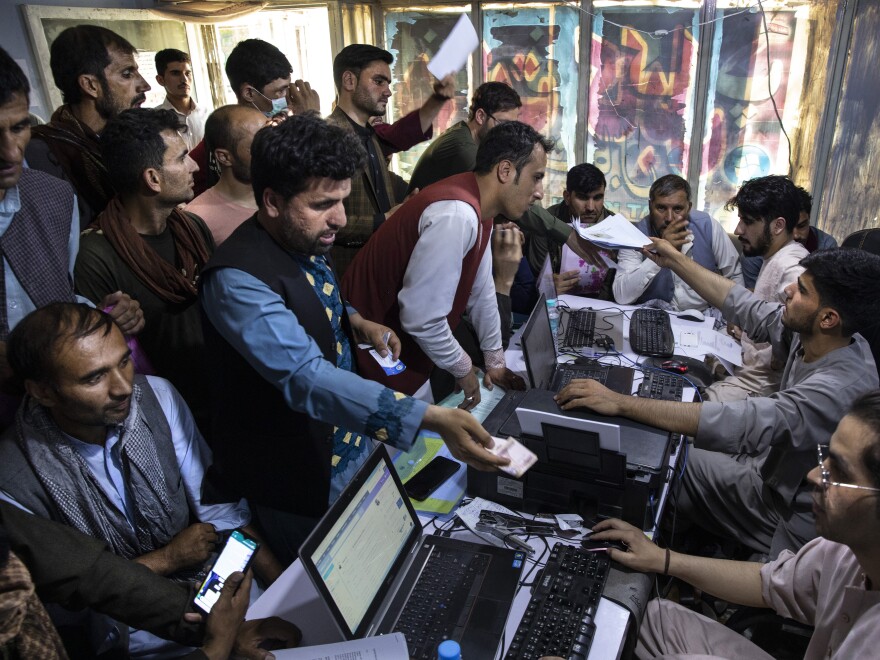 Afghan Special Immigrant Visa (SIV) applicants crowd into the Herat Kabul Internet cafe to apply for the SIV program on August 8, 2021 in Kabul, Afghanistan.