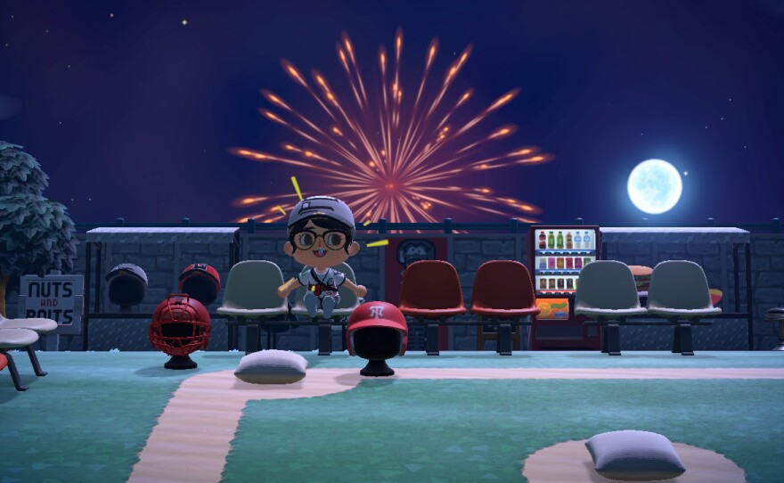 Kaliegh Klowoski's character in Animal Crossing sits in her creation of Jackson Field at night. There are fireworks in the backgroung.