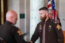 ACSD Cpl. Ben Fries accepting an award during a ceremony in 2025. He is currently the subject of a termination request by Sheriff Troy Hershberger for comments that appear to be making light of police shootings.