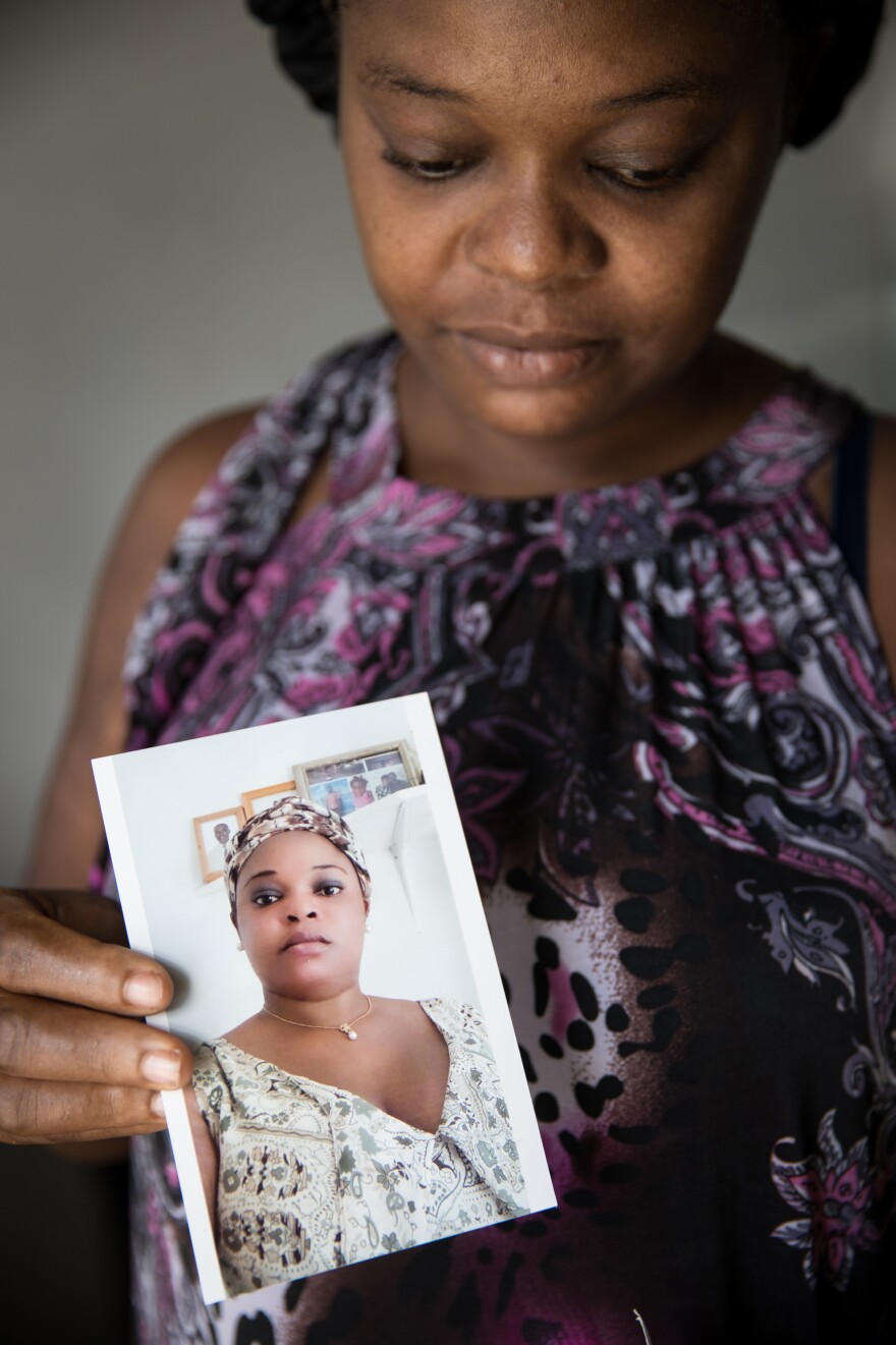 Abaco evacuee Sherrine Petit Homme LaFrance shows a photo of herself during better times. LaFrance is one of thousands of Haitians who were displaced to Nassau after Hurricane Dorian.