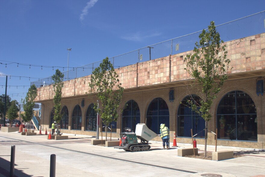 Workers at Market Square work around new shade trees and expanded sidewalks at Farmer's Market building at Market Square on July 23, 2025