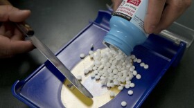In this Friday, July 8, 2016, file photo, a pharmacy technician fills a prescription at a pharmacy, in Sacramento, Calif. Lawmakers in almost half the states are considering ways in 2018 to reduce prescription drug costs, including importing them from Canada.