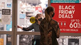 A shopper walks up to an At Home store just at opening time on Black Friday in the Dallas suburb of Frisco, Texas, Friday, Nov. 27, 2020. 