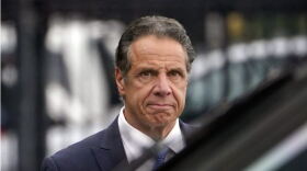 Former Gov. Andrew Cuomo, wearing a blue suit and tie.