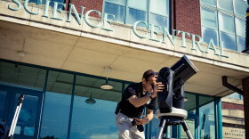 Science Central's Martin Fisher demonstrating the bank of telescopes outside the building