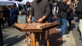 treet musician Matthew Dickinson plays his hammered dulcimer on a bright Saturday morning at the Soda City Market on Columbia's Main Street.