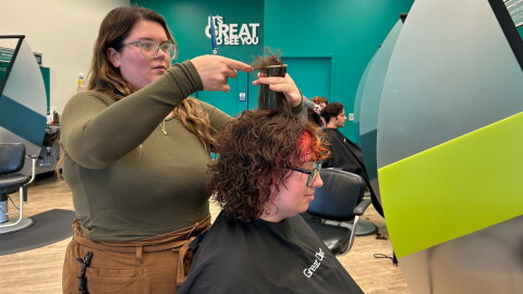 Teya Heller styles a customer's hair at Great Clips in Dickson City.