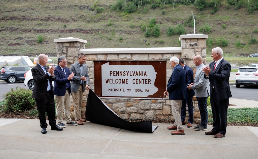 State officials unveil the new I‑99 Welcome Center sign during a ceremony marking the official designation of U.S. Route 15 as part of Interstate 99.