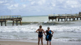 Curious beachgoers stand in front of part of Anglin's Fishing Pier that collapsed into the ocean after Hurricane Nicole arrived, Thursday, Nov. 10, 2022, in Lauderdale-by-the-Sea. Tropical Storm Nicole made landfall as a hurricane early Thursday near Vero Beach. It's such a sprawling storm that it has covered nearly the entire peninsula while reaching into Georgia and South Carolina. 