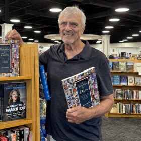 Jeff Boerger holds a copy of his book The Perception of Doors at Schuler Books in Okemos, MI.