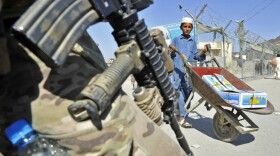On the Afghan side of the border with Pakistan, a U.S. soldier stood guard last month as a boy walked by in Nangarhar province. 