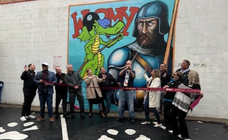 The Carbondale Chamber of Commerce celebrates the unveiling of a mural dedicated to David Trampier artist for Dungeons and Dragons.