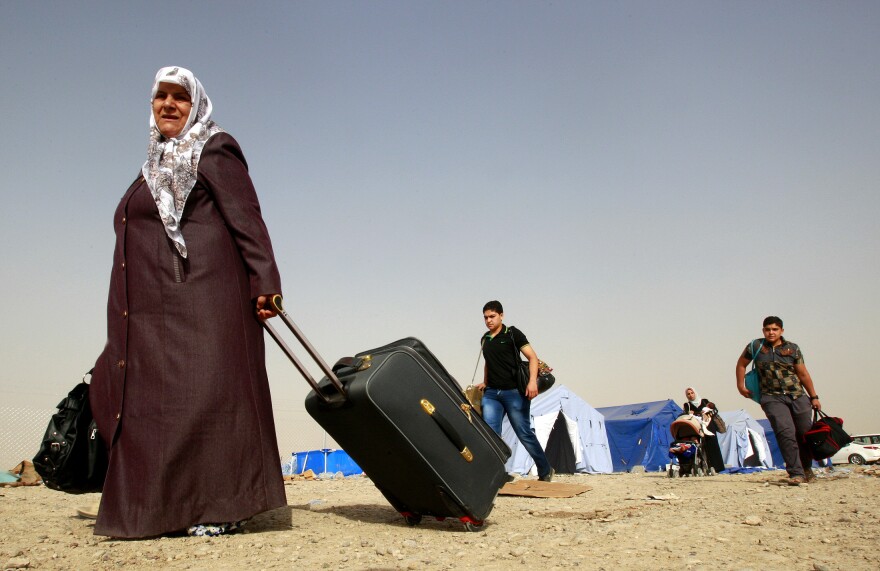 Refugees fleeing from Mosul head to the self-ruled northern Kurdish region in Irbil, Iraq, on June 12.