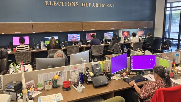 Temporary "surge" workers on the farthest row under the elections department sign were working to clear the backlog of voter registration forms on Sept. 29, 2005