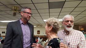 State Treasurer Michael Frerichs (left) shares a laugh with Sally and David Egler of Macomb before the McDonough County Democratic Central Committee dinner.