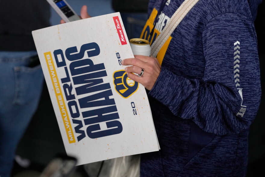 A Milwaukee Brewers fan holds a sign as they arrive for a rally during the baseball team’s World Series parade, Friday, Oct. 30, 2026, in Milwaukee. (AP Photo/Nam Huh)