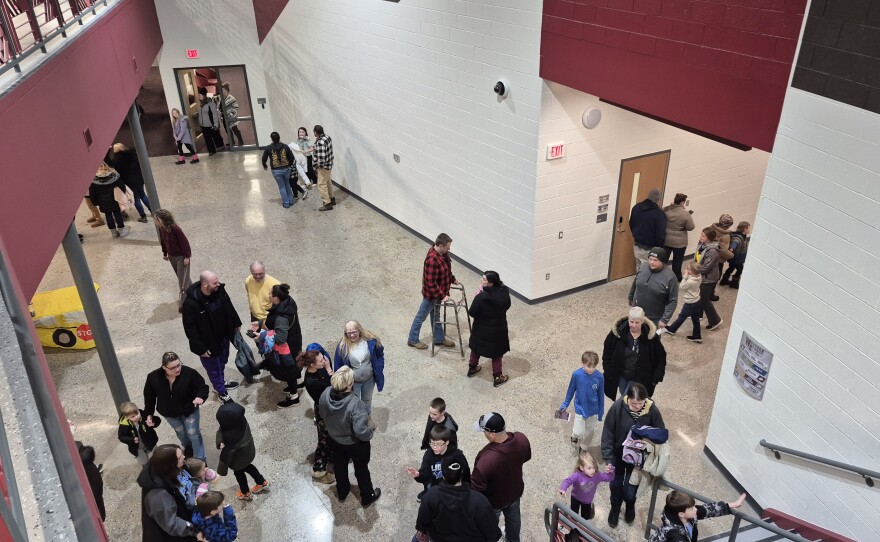 Parents and students walk around Western Elementary School during an open house.