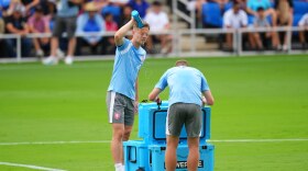 Lukas Cerv, of the Czechia men's national soccer team, refreshes himself while working out in hot Texas weather during a public training session on Saturday, June 6, 2026, in Mansfield, Texas, ahead of the World Cup soccer tournament.