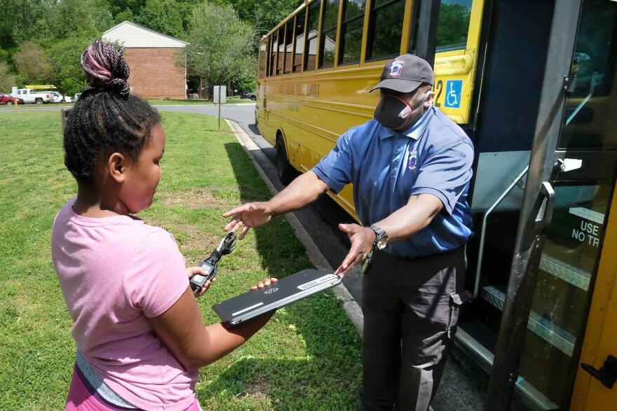 A Charlotte-Mecklenburg Schools employee delivers devices to help students learn from home.